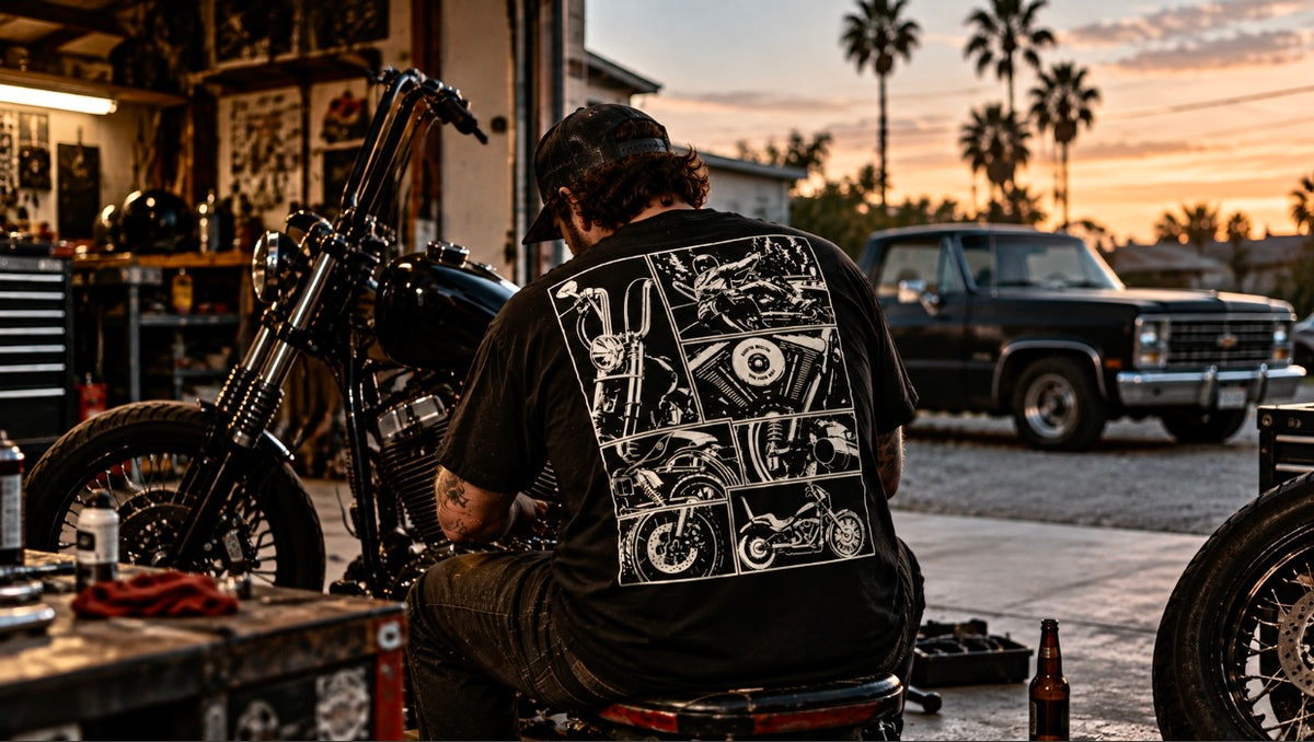 Cinder Route black graphic tee in a motorcycle garage at sunset